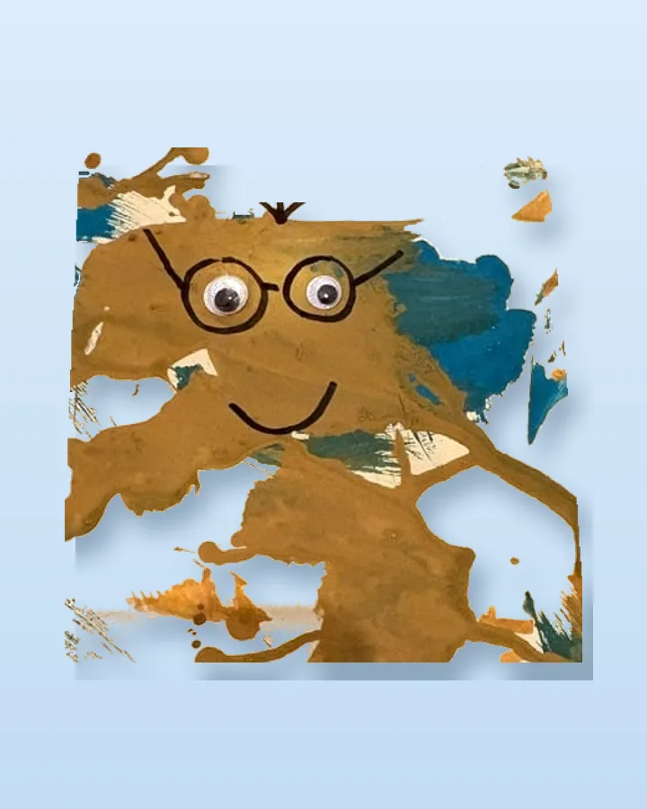 The painted face lifted off its card, standing on a plain surface with a shadow: the paint, the googly eyes and the glasses exactly as made.
