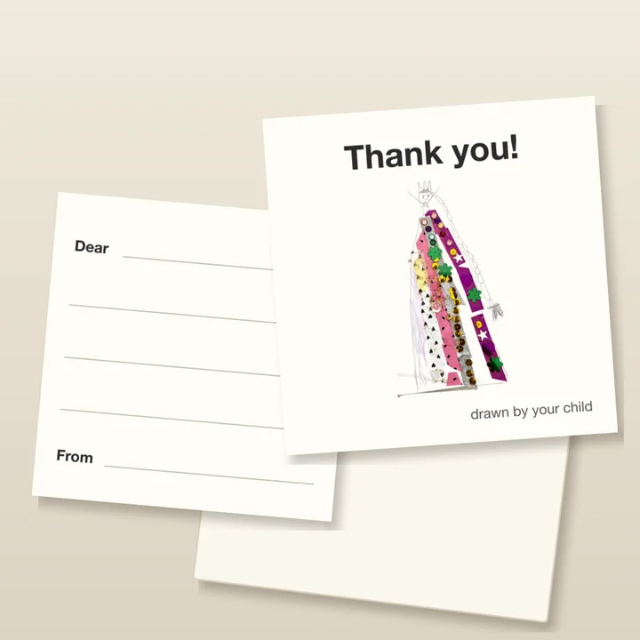 A mockup of the thank-you notes on a desk: "Thank you!" above a child's drawing of a queen in a sequinned dress, and beside it the back, with lines to write on from "Dear" to "From".