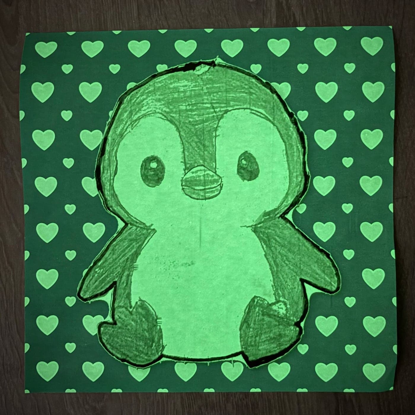 The same glow-in-the-dark print, photographed with the lights off.